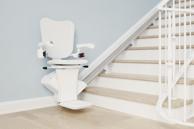 AmeriGlide liberty stairlift installed at the base of stairs to assist with safe mobility between floors