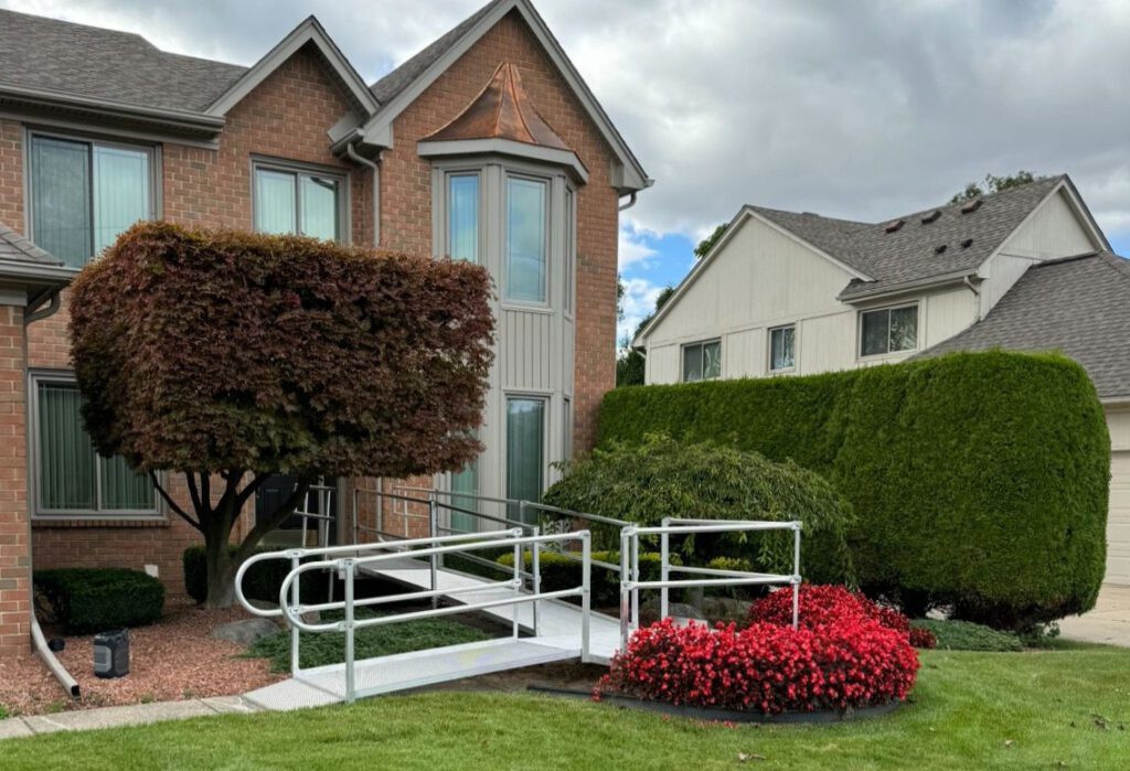Aluminum wheelchair ramp with turn leading to front door entrance